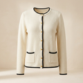 AI-generated illustrative image of a women's ivory cardigan with black trim and gold-tone buttons